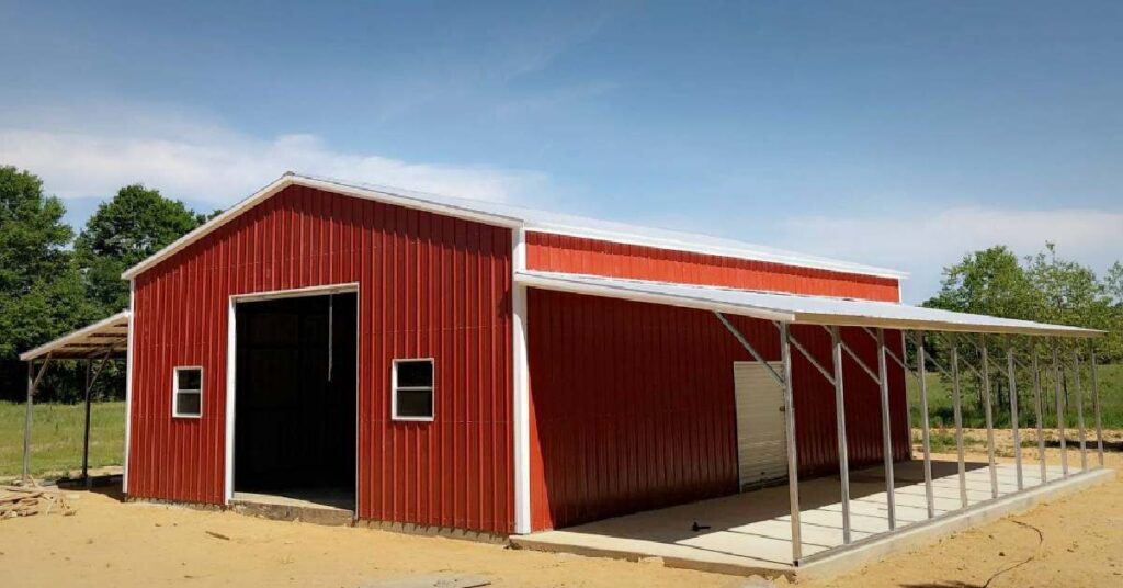 Red iron barn with overhang for sale at RampUp Storage in Troy, tX